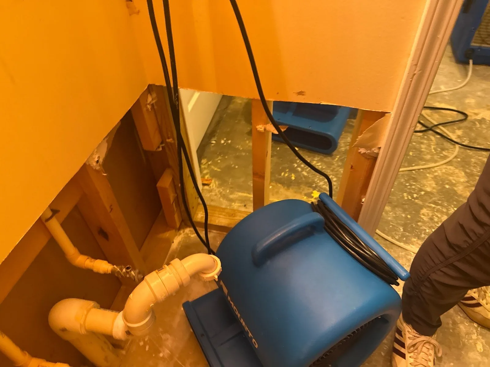 Water mitigation setup with blue air mover and exposed wall piping — serving Dallas, GA.