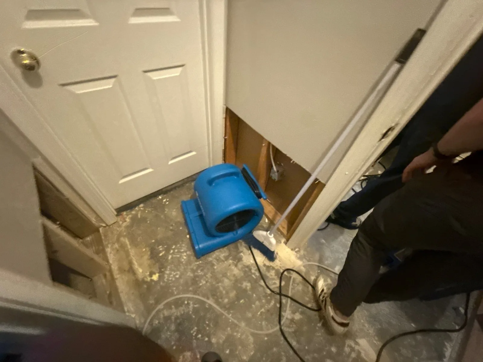 Dehumidifier in a room with exposed wall studs and concrete flooring, used during water mitigation — serving Dallas, GA.