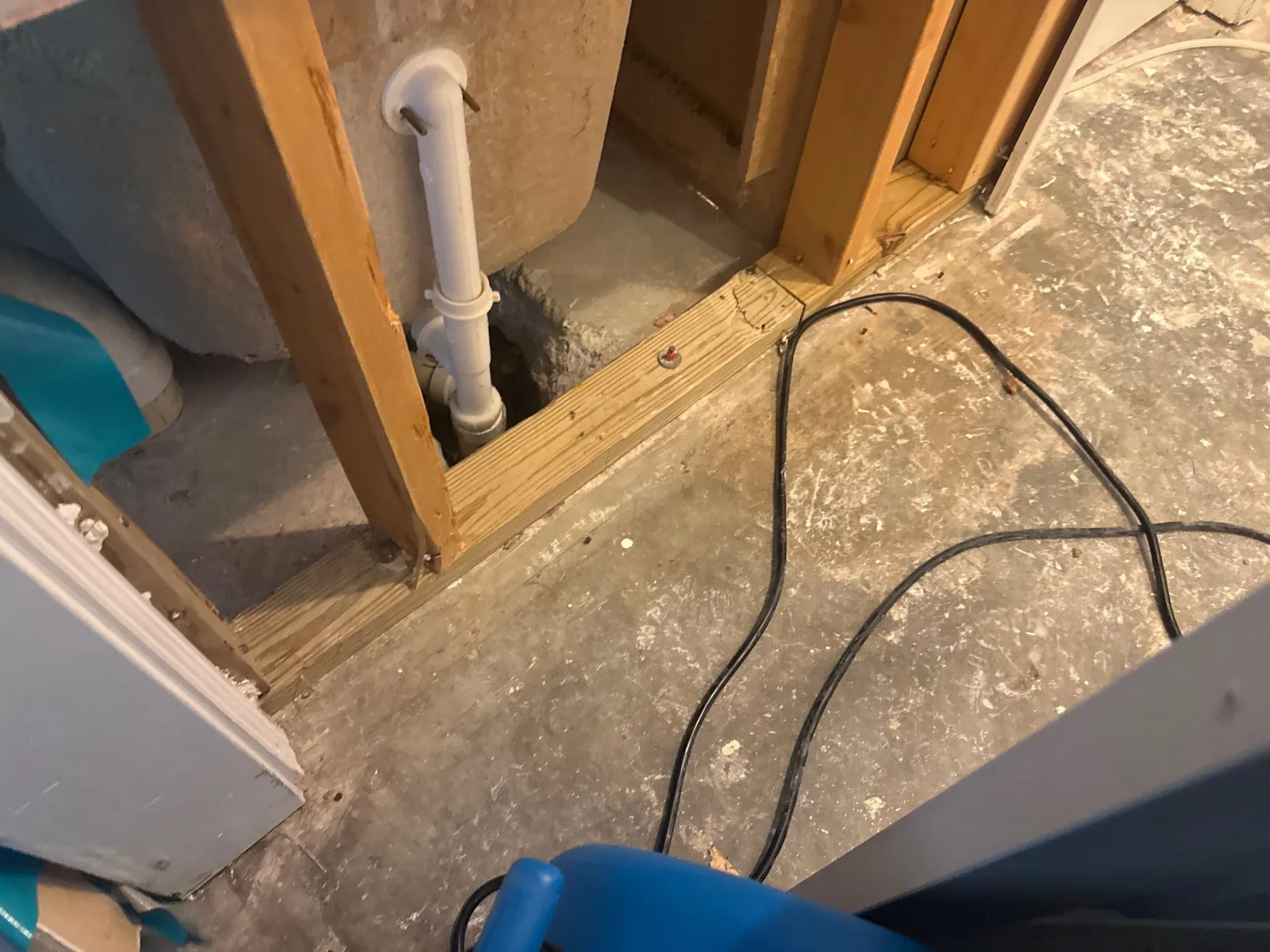 Exposed flooring with drain pipe and wooden supports at a construction site — serving Dallas, GA.
