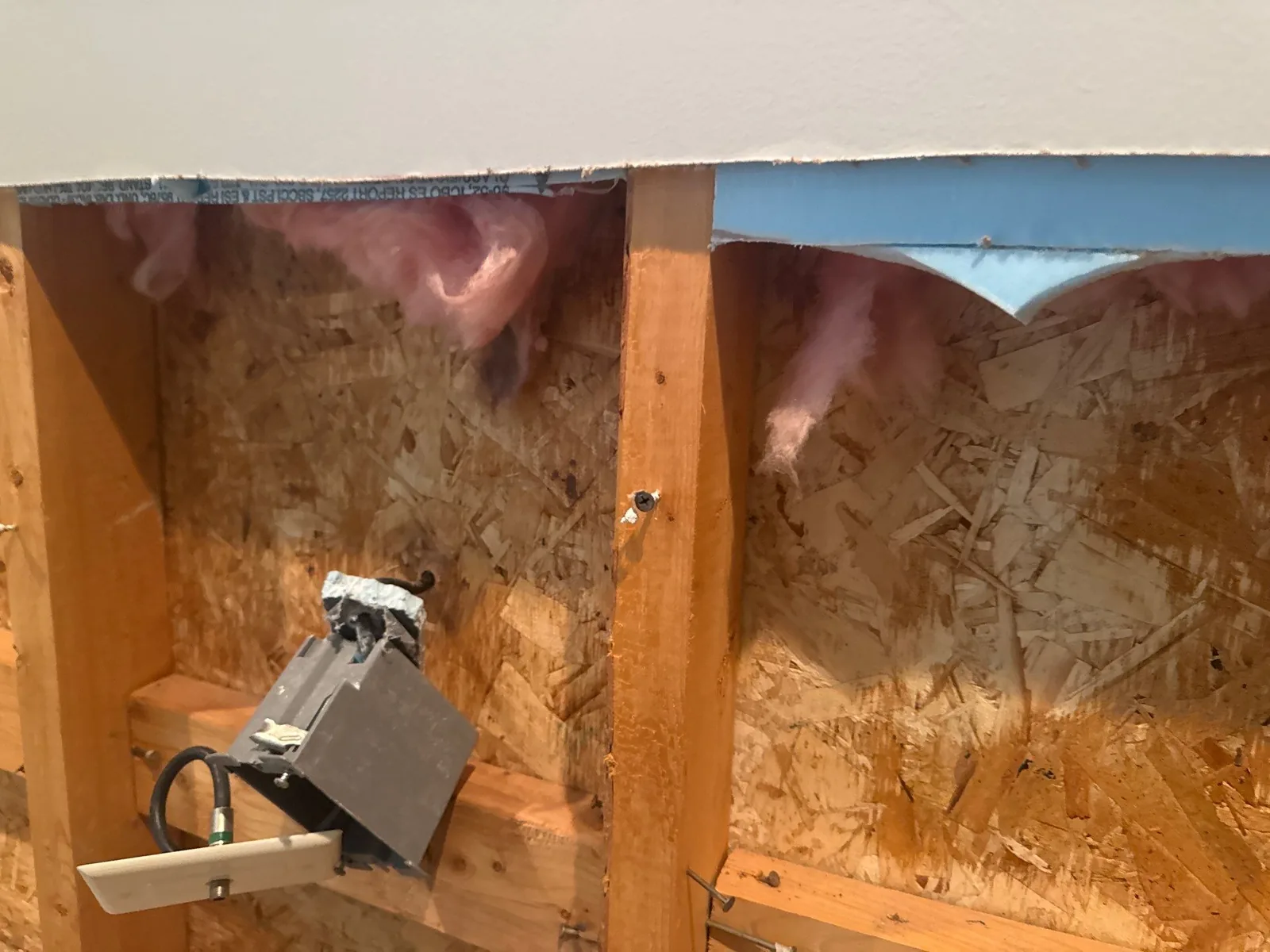 Exposed wall with electrical wiring and pink insulation visible during mitigation phase — serving Dallas, GA.