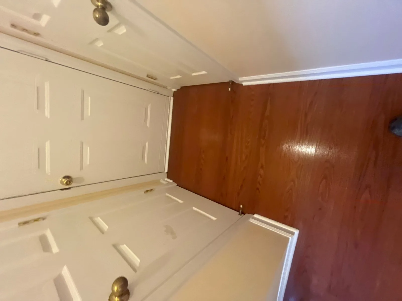 Corner of a room with two white doors and new wooden flooring — serving Dallas, GA.