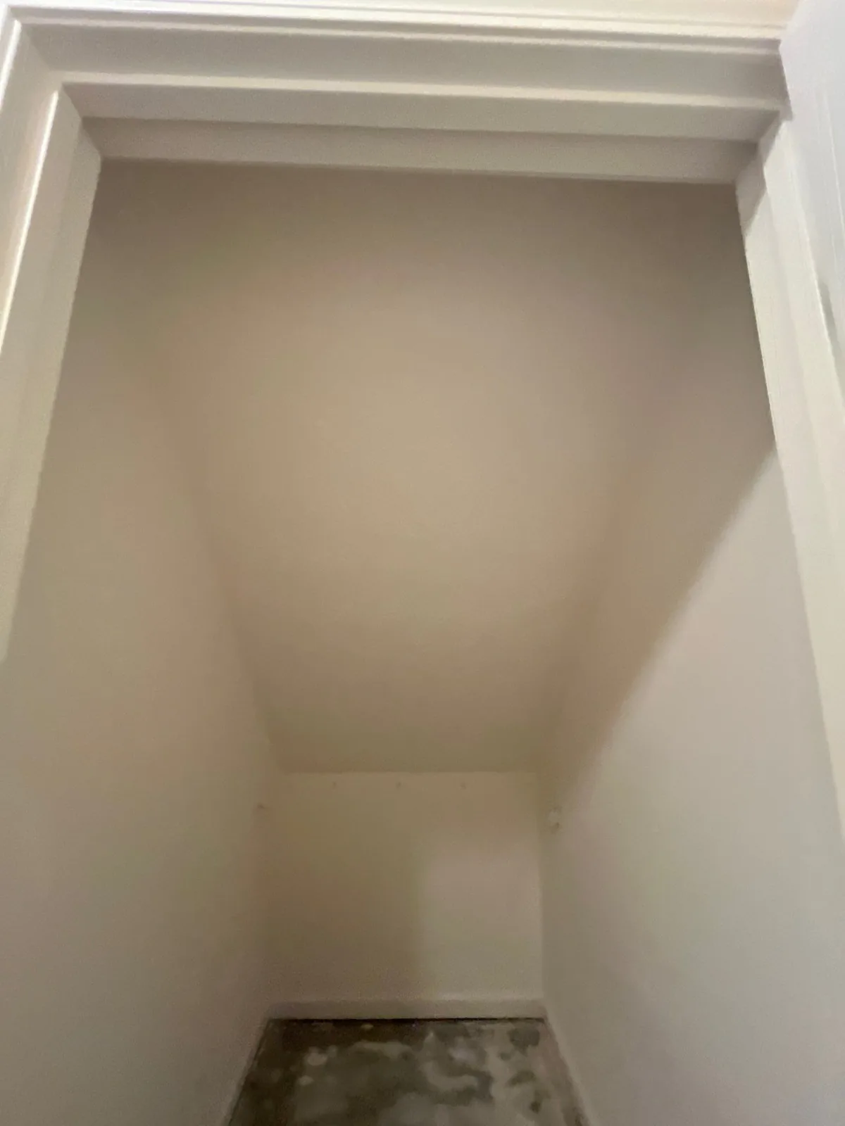 Empty closet with finished walls and an unfinished floor during remodeling — serving Dallas, GA.