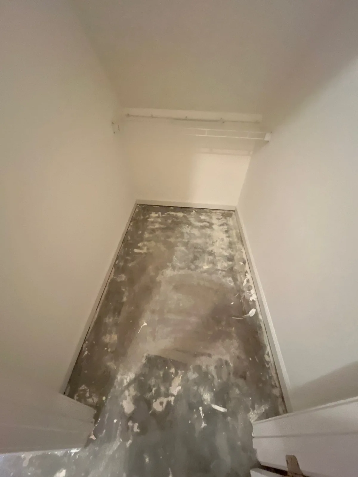 Empty room with unfinished floors and bare walls, indicating an early remodeling stage — serving Dallas, GA.