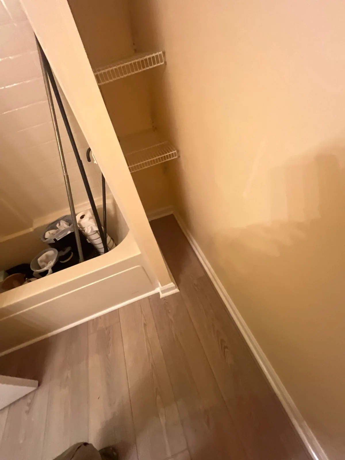 Bathtub installation next to a new wall with baseboard and wooden flooring — serving Dallas, GA.