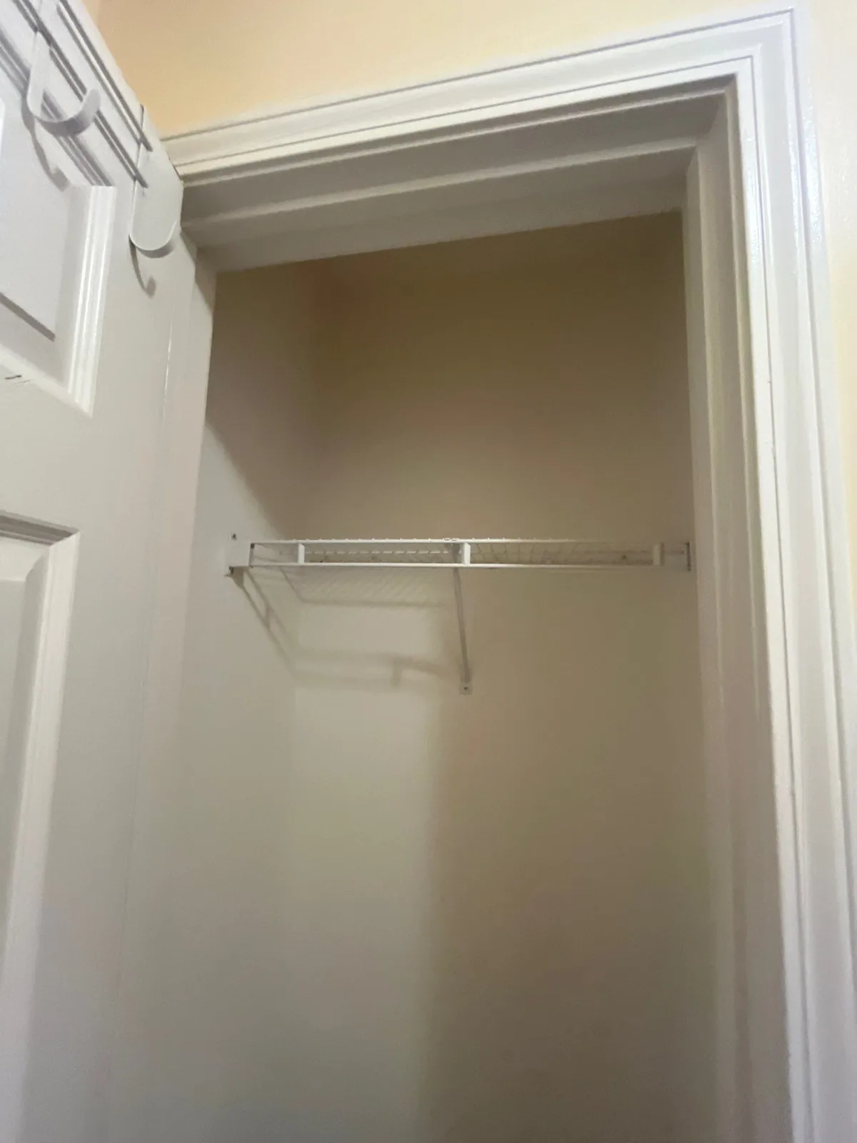 Interior view of a small closet with an installed wire shelf — serving Dallas, GA.