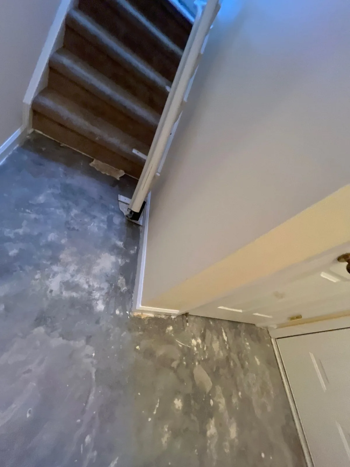 Staircase and hallway with exposed subflooring in a restoration scene — serving Dallas, GA.