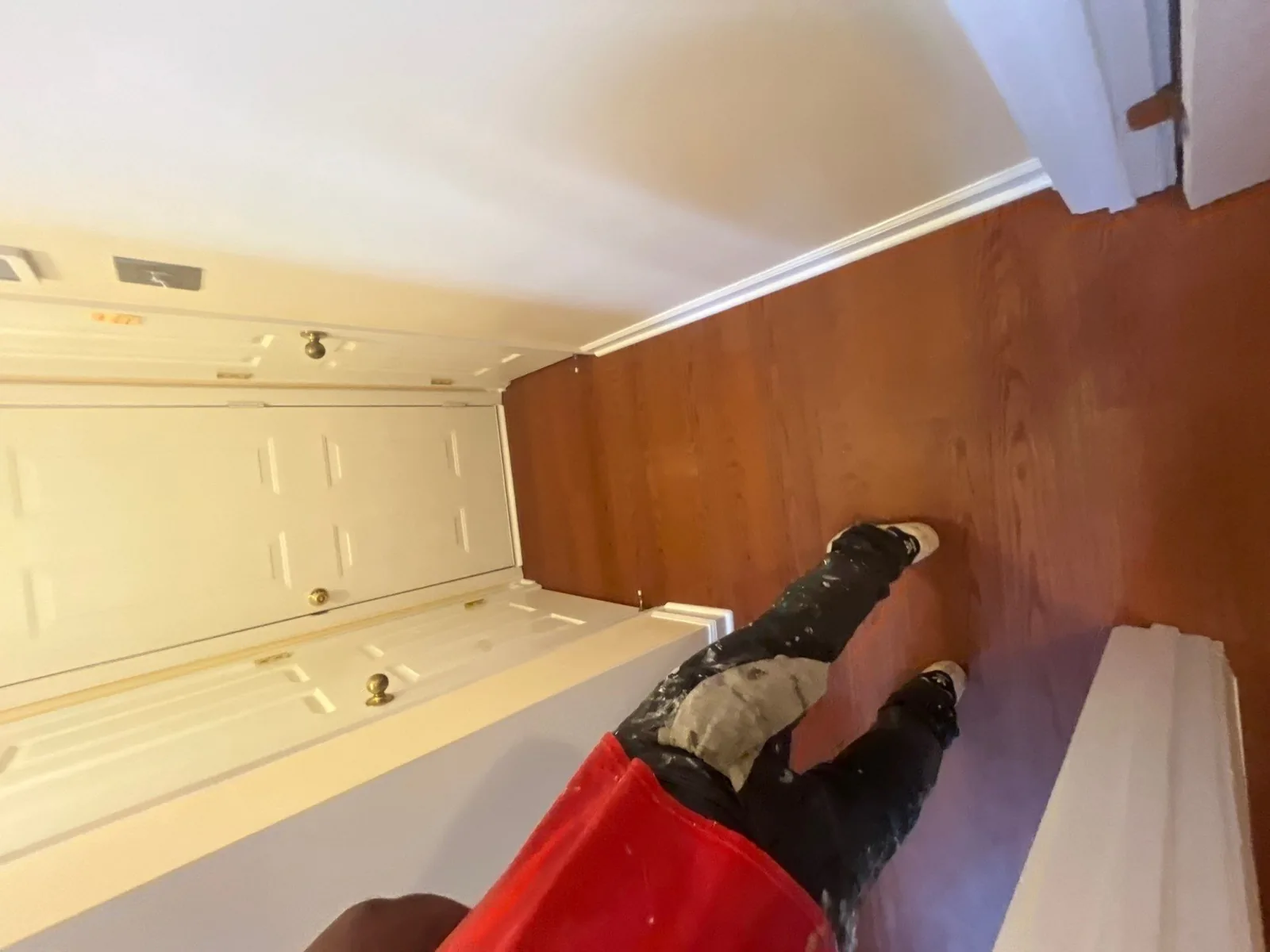Person in work attire standing in a hallway with new hardwood flooring — serving Dallas, GA.