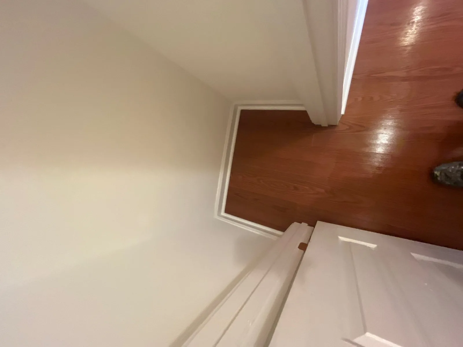 Interior corner of a room with new light-colored walls and polished wooden flooring — serving Dallas, GA.