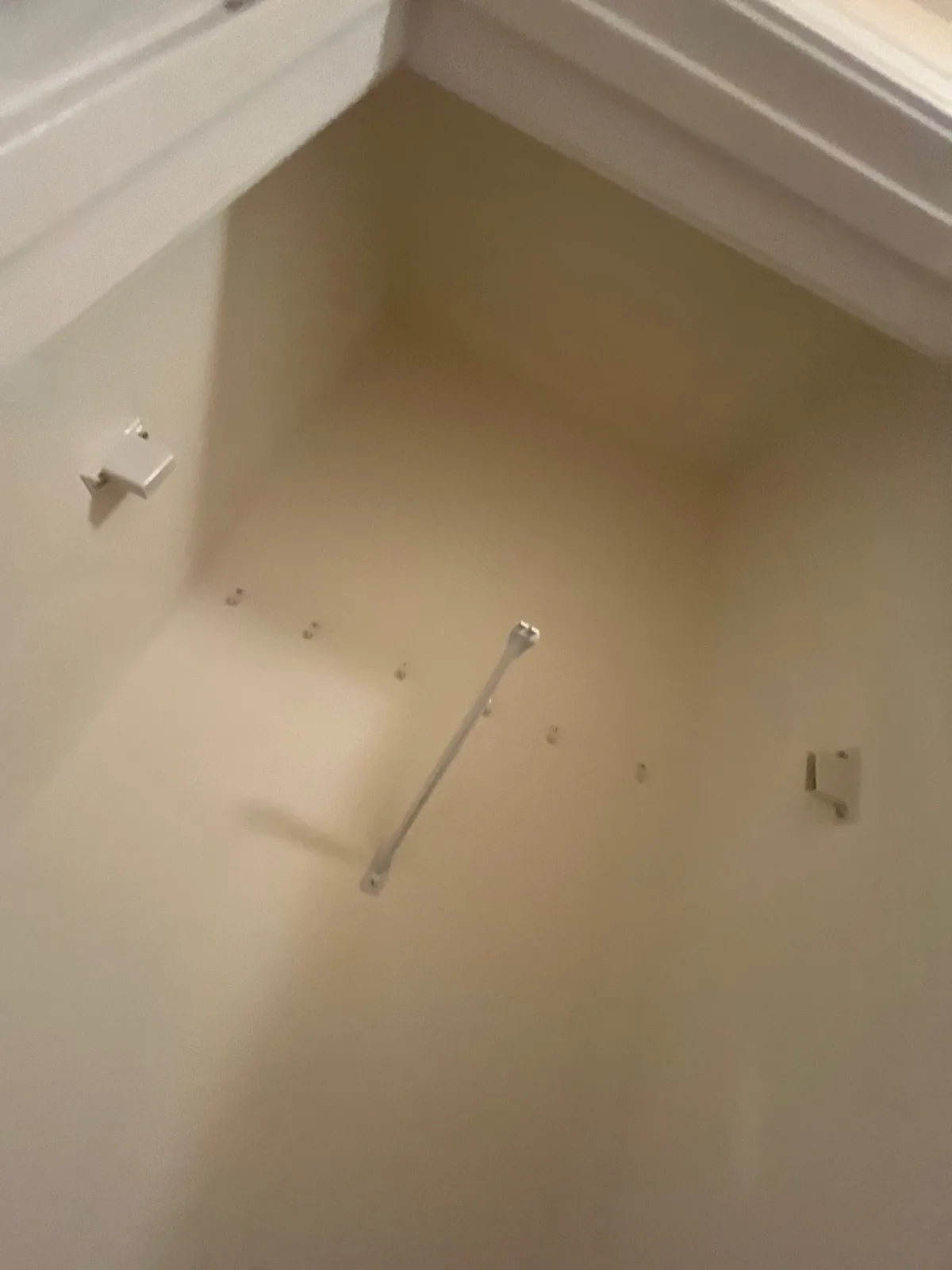 Completed remodeled storage space with clothing rod and brackets installed — serving Dallas, GA.