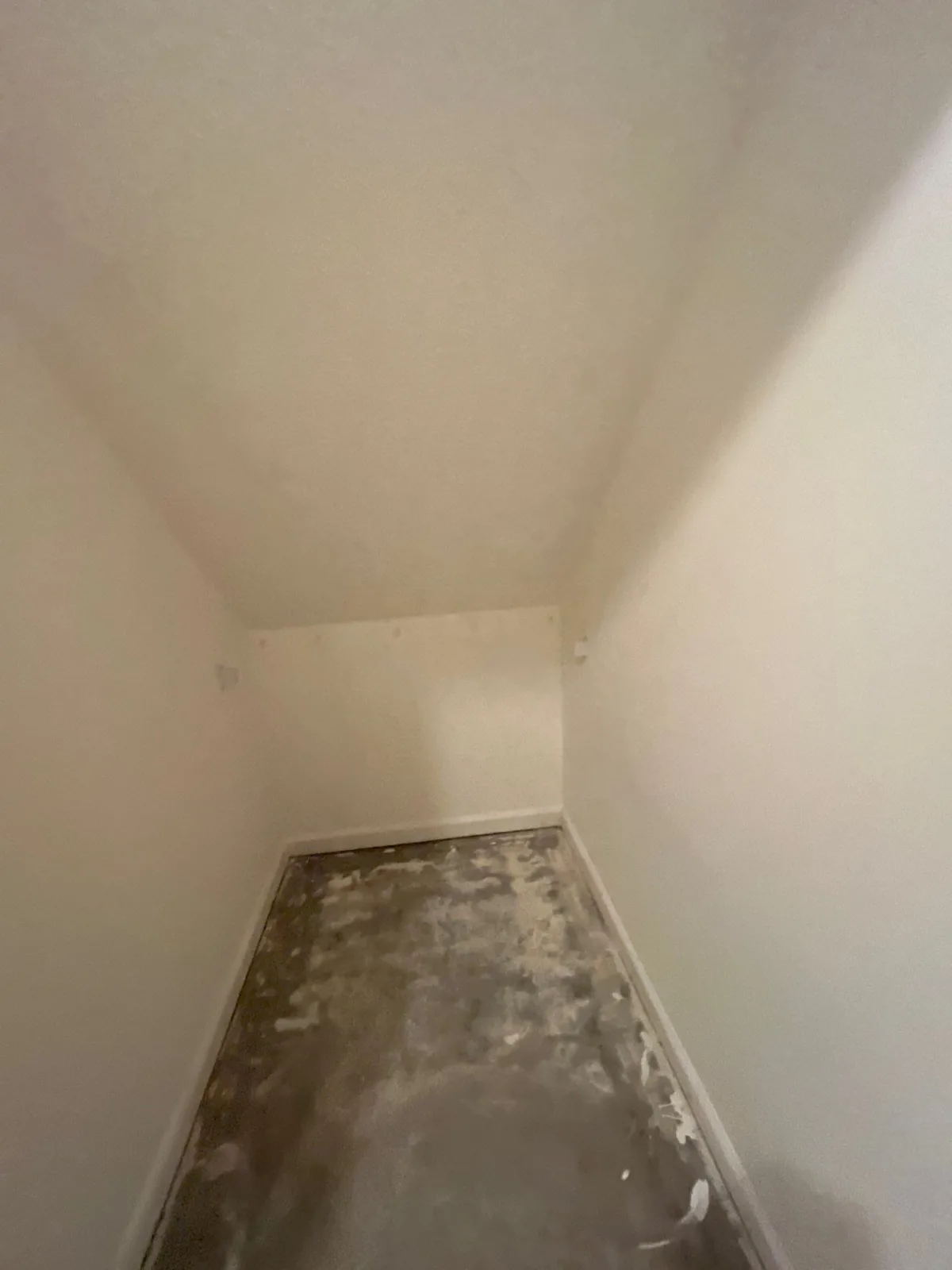 An empty room showing bare concrete flooring and unpainted walls, indicating the early stage of remodeling — serving Dallas, GA.