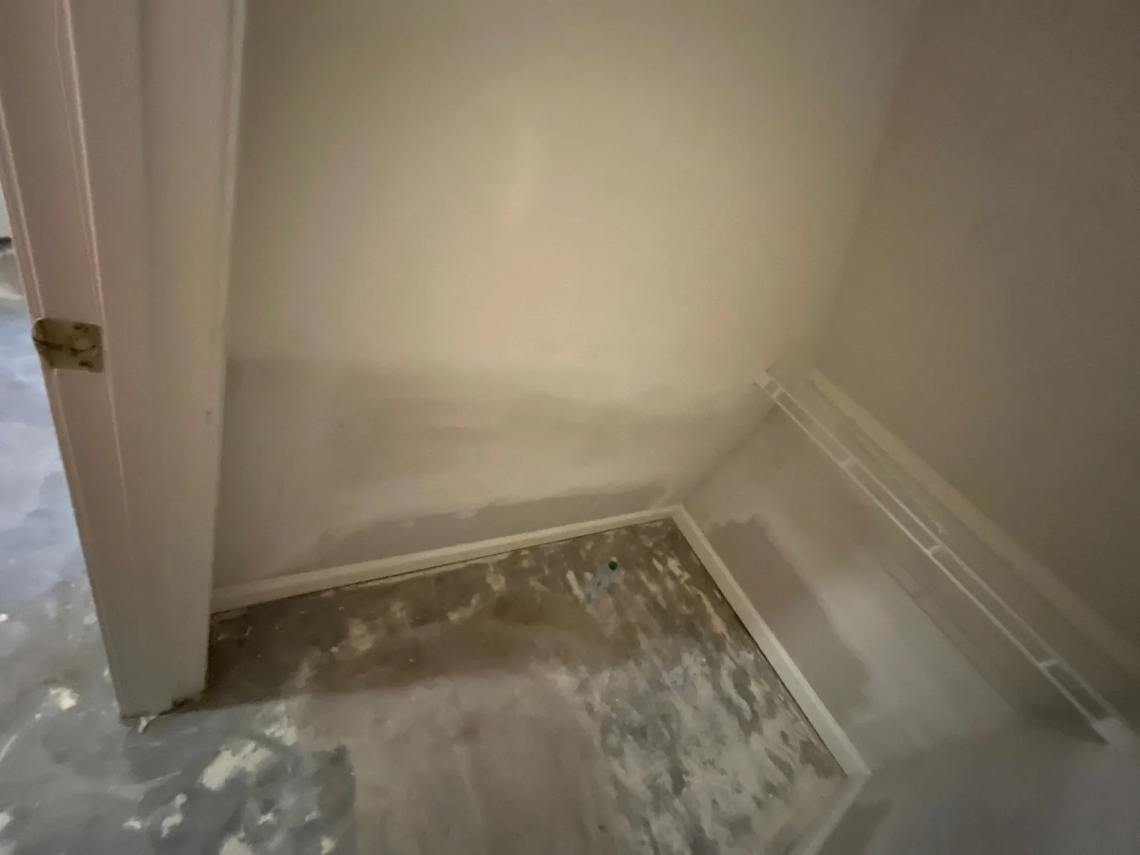 Partially completed wall in a small room with patchwork and a bare concrete floor — serving Dallas, GA.