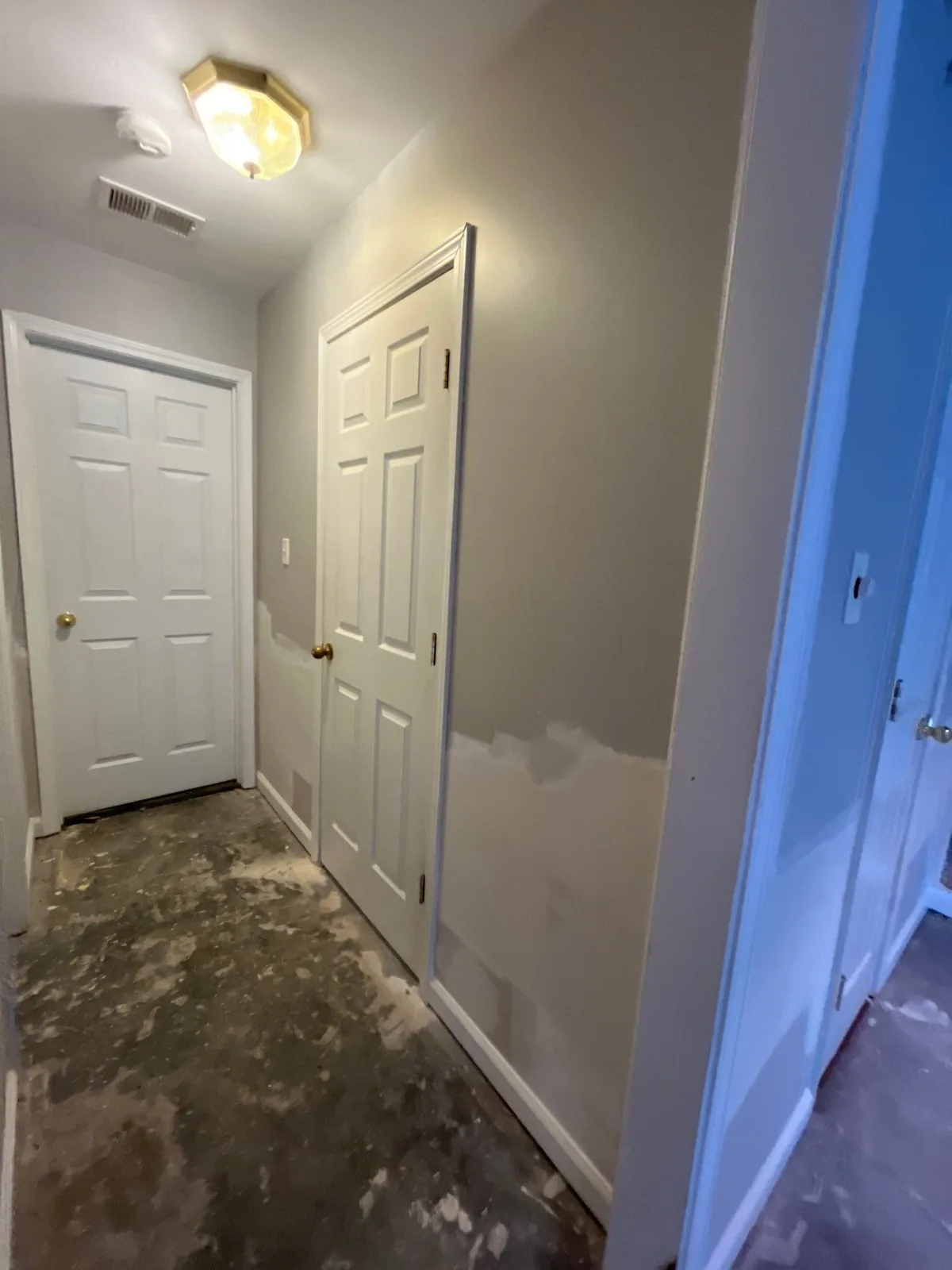 Hallway with patched walls and bare floor during construction — serving Dallas, GA.