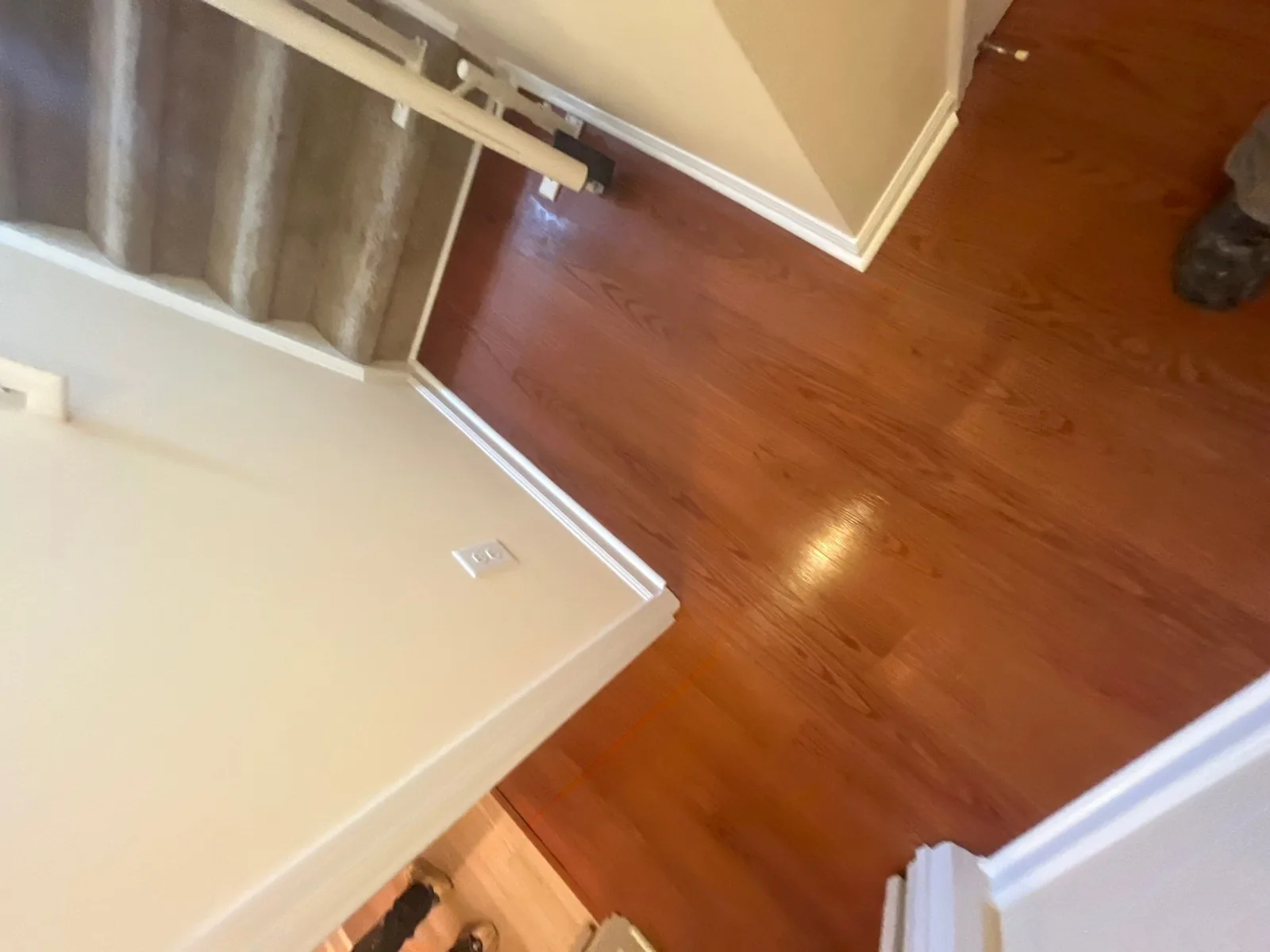 Completed remodeling with new hardwood flooring near carpeted stairs — serving Dallas, GA.