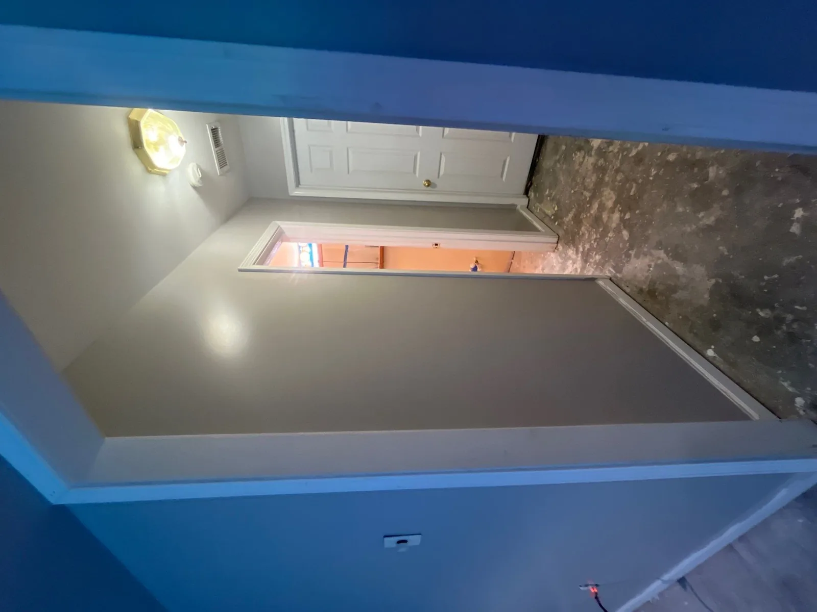 Hallway during a restoration project with bare flooring and freshly painted walls — serving Dallas, GA.