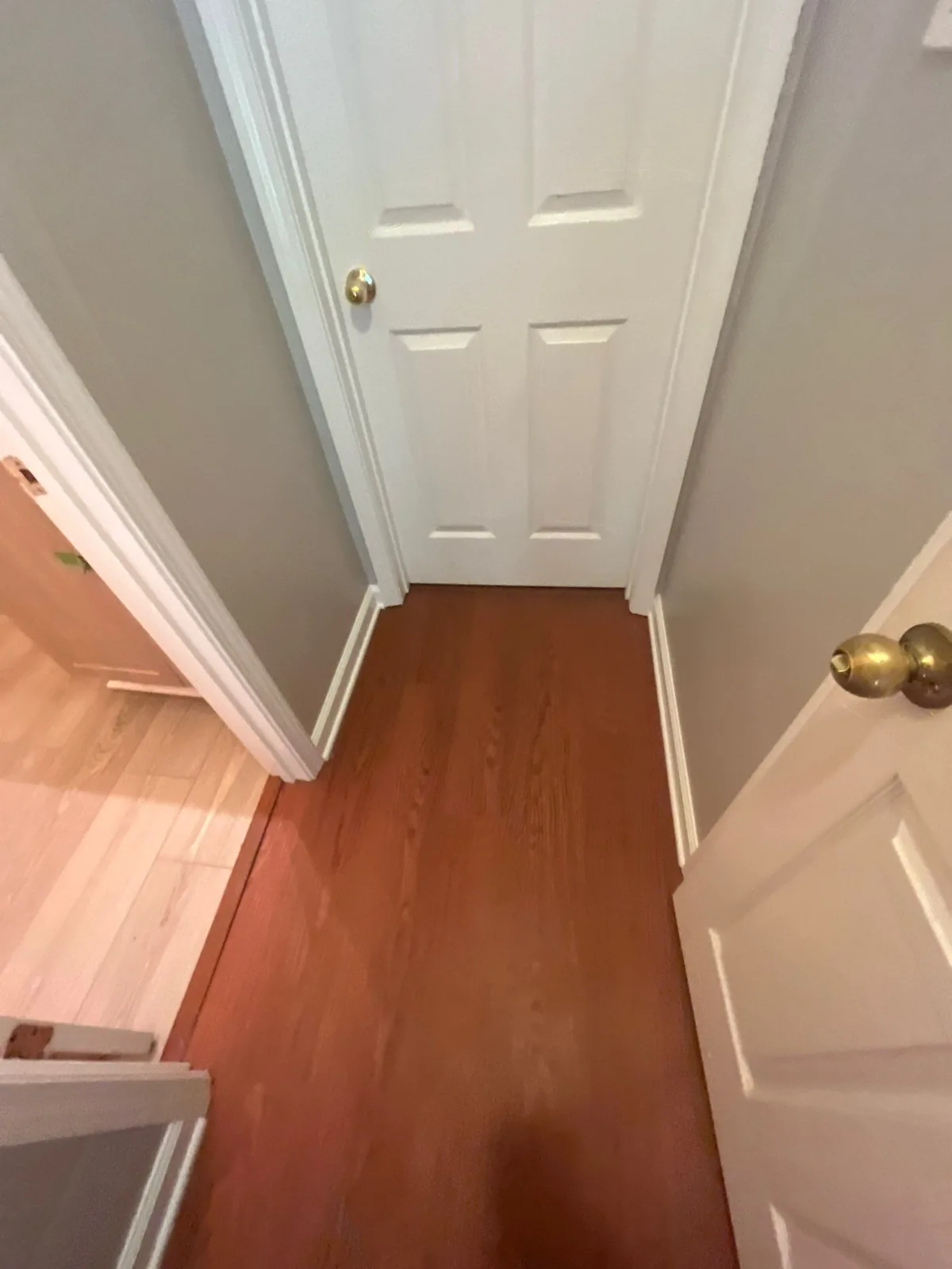 Completed hallway remodeling with new paint and wood flooring — serving Dallas, GA.
