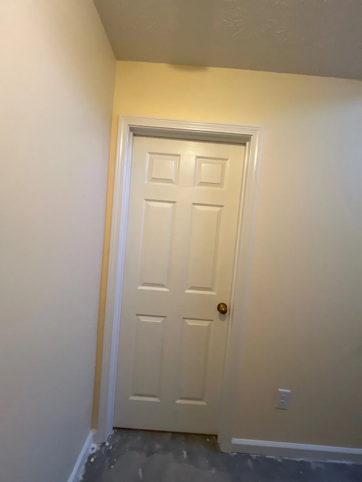 Partially finished hallway with freshly painted yellow walls and a bare floor — serving Dallas, GA.
