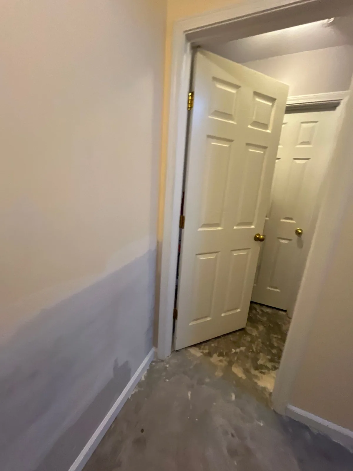 Hallway with open doors and in-progress wall preparation during remodeling — serving Dallas, GA.