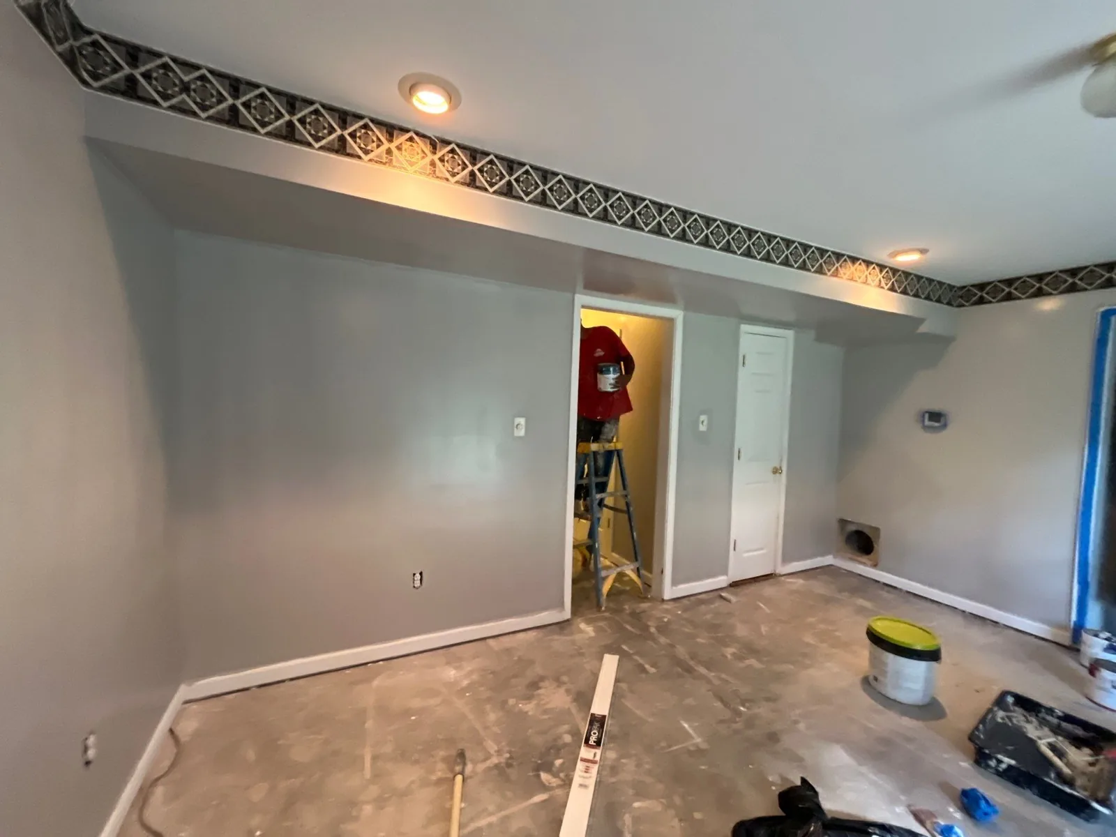 Room with fresh paint, exposed flooring, and remodeling materials — serving Dallas, GA.