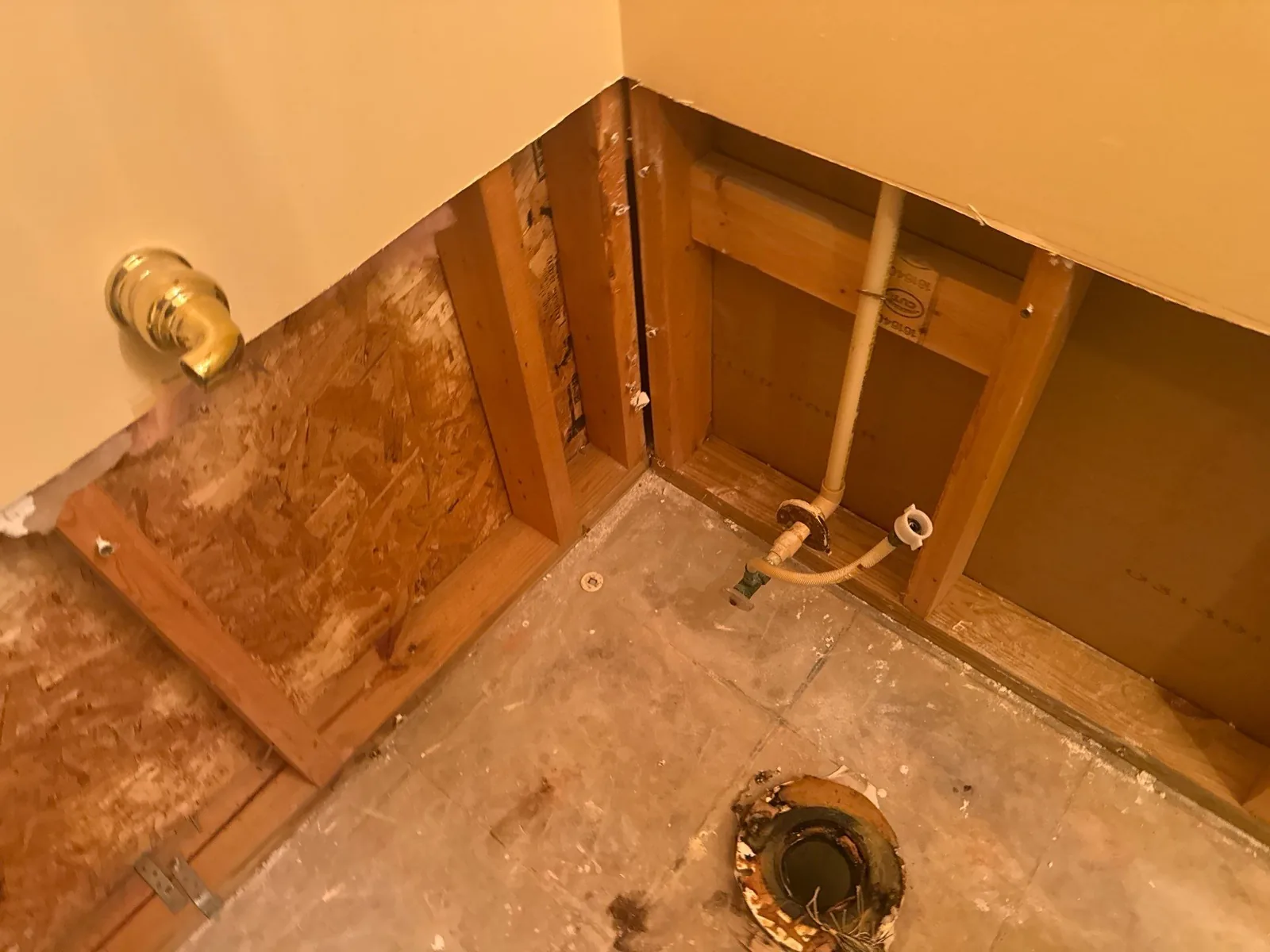 Bathroom undergoing water restoration with open wall and visible plumbing — serving Dallas, GA.