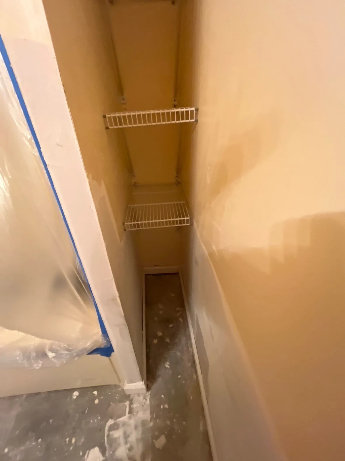 Unfinished closet with wire shelving and construction debris on the floor — serving Dallas, GA.