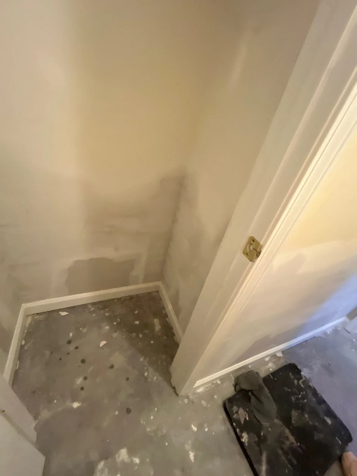 Room under construction with drywall repairs and an unfinished floor — serving Dallas, GA.
