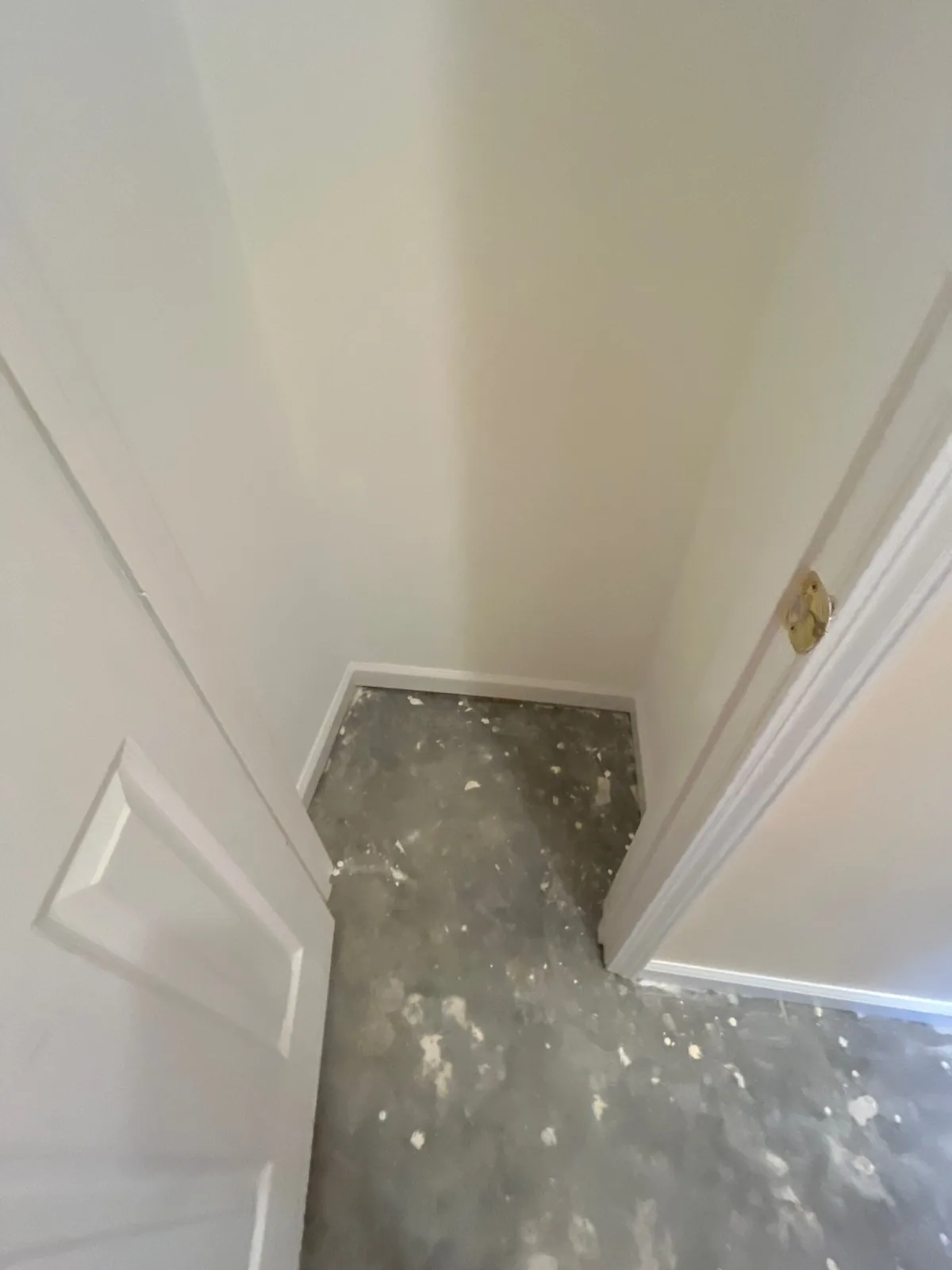 Corner of a room with unfinished concrete floor and newly painted walls — serving Dallas, GA.