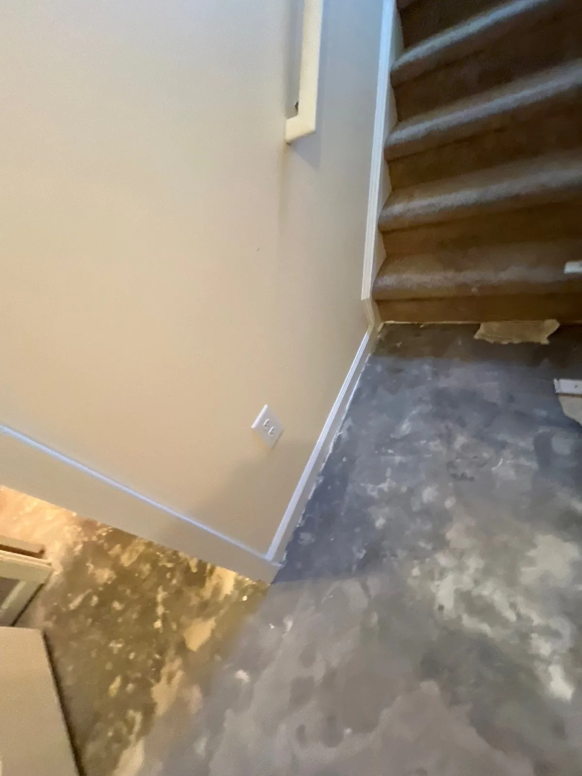 Stairway area with carpeted stairs and concrete flooring undergoing work — serving Dallas, GA.