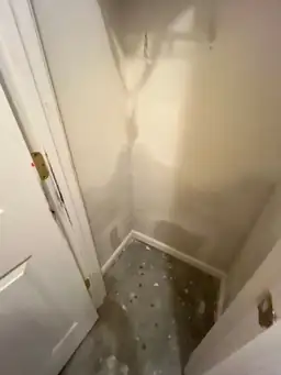 Water damage mitigation work in a room corner with stained walls and visible patches — serving Dallas, GA.
