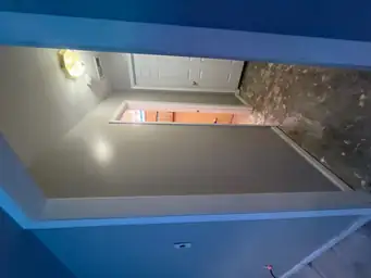 Hallway during a restoration project with bare flooring and freshly painted walls — serving Dallas, GA.