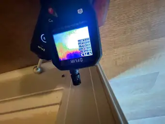 FLIR imaging moisture meter reading 71.5 degrees at baseboard junction showing high humidity thermal scan after water intrusion — Marietta, GA