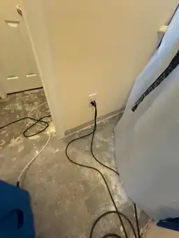 Room with bare concrete floor and electrical cords during water mitigation — serving Dallas, GA.
