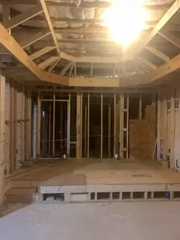 Basement framing with arched window rough-in and OSB subfloor decking visible during basement renovation — Atlanta, GA