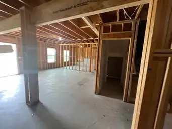Basement framing with exposed wood stud walls, door rough openings, and daylight visible through multiple windows — Metro Atlanta, GA