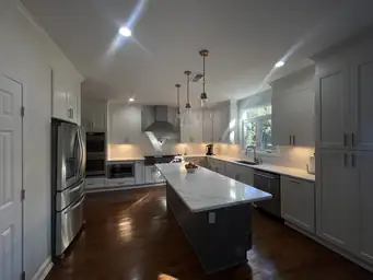 Kitchen renovation with wood-plank ceiling, white shaker cabinets, stainless appliances, and epoxy floor — Metro Atlanta, GA