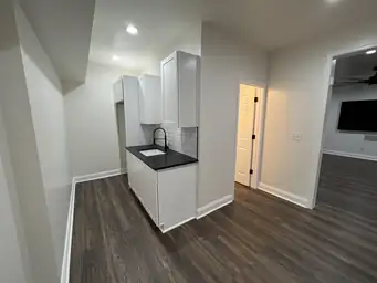 Wet bar renovation with white shaker cabinets, subway tile backsplash, and dark wood plank ceiling — Metro Atlanta, GA
