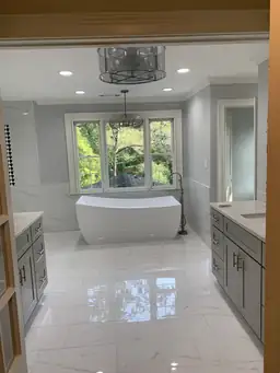 Renovated kitchen with white marble tile backsplash, gray shaker cabinets, quartz island, and recessed lighting — Atlanta, GA