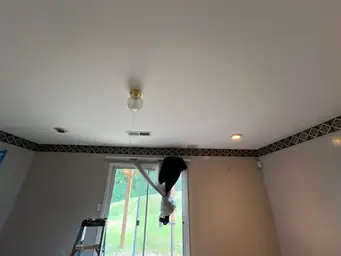Interior room with step ladder and plastic-covered window, showing partially completed drywall work — serving Dallas, GA.