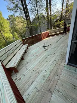 Broad view of natural pressure-treated deck boards fully replaced and ready for staining during deck restoration — Marietta, GA