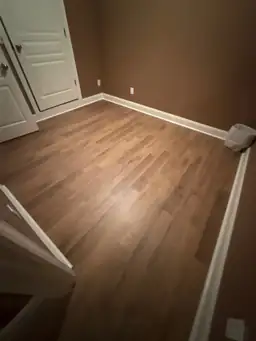 Basement staircase fully covered in plastic sheeting with blue painter tape edge masking during water damage containment — Marietta, GA