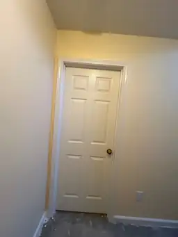 Partially finished hallway with freshly painted yellow walls and a bare floor — serving Dallas, GA.