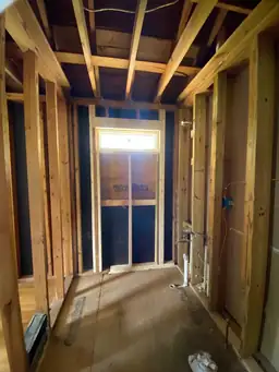 Renovated living space after home remodel with light hickory hardwood floors, fresh white walls, and natural window light — Marietta, GA