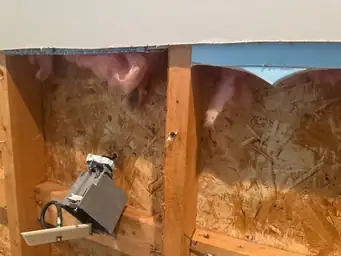 Exposed wall with electrical wiring and pink insulation visible during mitigation phase — serving Dallas, GA.