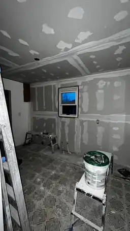 Kitchen storm damage repair showing new drywall on ceiling and walls with joint compound drying between coats — Acworth, GA