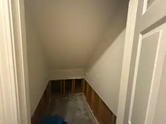 A room with exposed wall studs and flooring, indicating ongoing water restoration work — serving Dallas, GA.