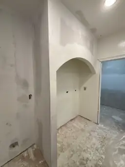 Drywall work in progress — new arched niche framed and drywalled in kitchen area during renovation — Powder Springs, GA