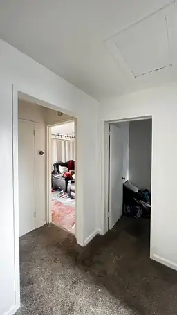 Interior hallway with storm-damaged ceiling, patched drywall seams, and water-stained carpet before storm damage repair — Acworth, GA