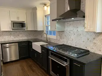 Kitchen renovation with dark shaker cabinets, stainless range hood, and hexagon marble tile backsplash — Metro Atlanta, GA