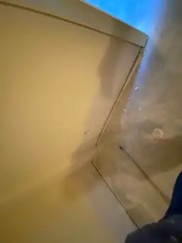 Fresh gray drywall panels with joint compound patches installed on basement wall during water damage repair — Marietta, GA