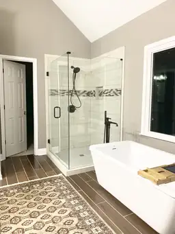 Master bathroom remodel with frameless glass corner shower, marble tile surround, and freestanding soaking tub — Metro Atlanta, GA